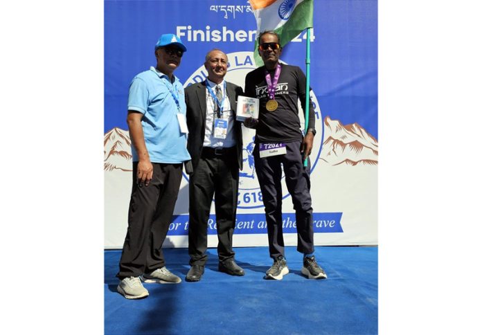 Sudhir Anand posing with dignitary after completing race in Ladakh. Sudhir Anand posing with dignitary after completing race in Ladakh.