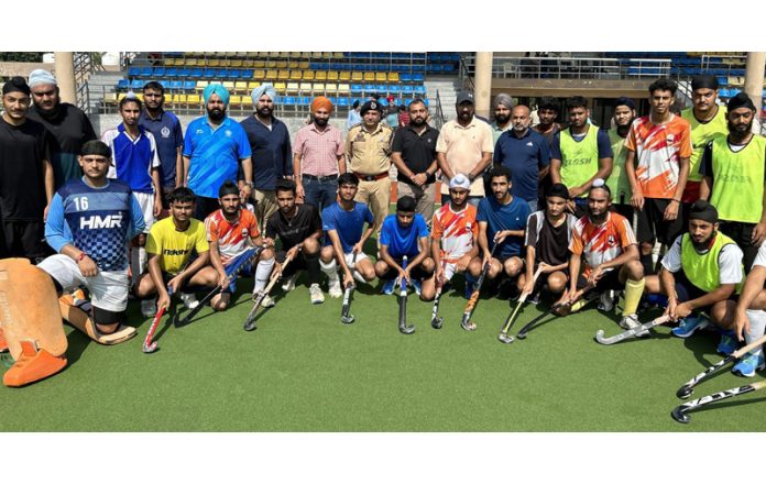 Selected Jammu & Kashmir Junior National Hockey Team posing along with DIG Jammu, Shiv Kumar Sharma and others.