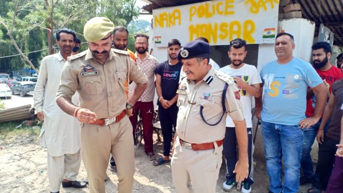DIG JSK Range, Shiv Kumar Sharma, interacting with police officers and civilians at Mansar area of Samba district on Sunday.