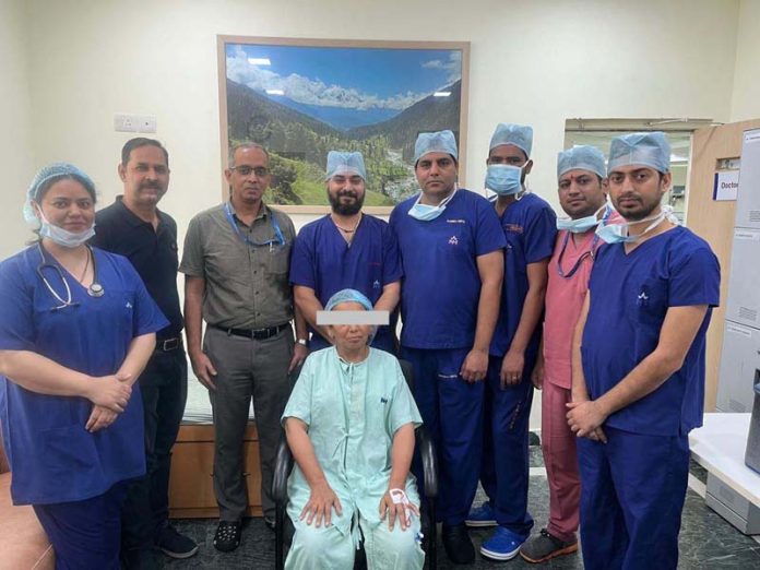 A team of doctors from SMVD Narayana Hospital posing with a patient on whom they successfully performed dual surgery.