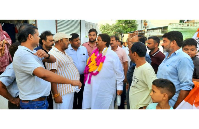 Cong candidate Raman Bhalla during door to door campaign in R S Pura.