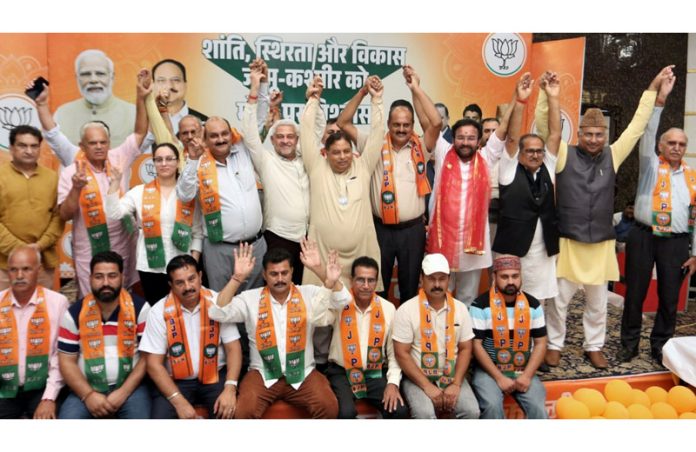 DSS leaders posing for a photograph with Union Minister, G K Reddy and senior BJP leaders after joining the party at Jammu on Wednesday.