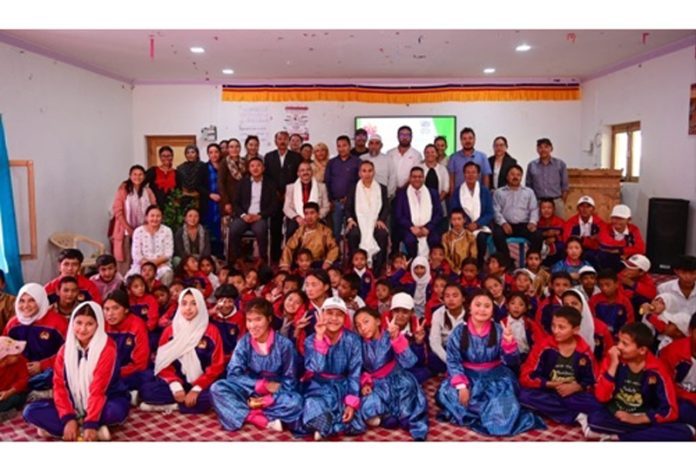 Justice Tashi Rabstan along with others posing with children of the school. Justice Tashi Rabstan along with others posing with children of the school.