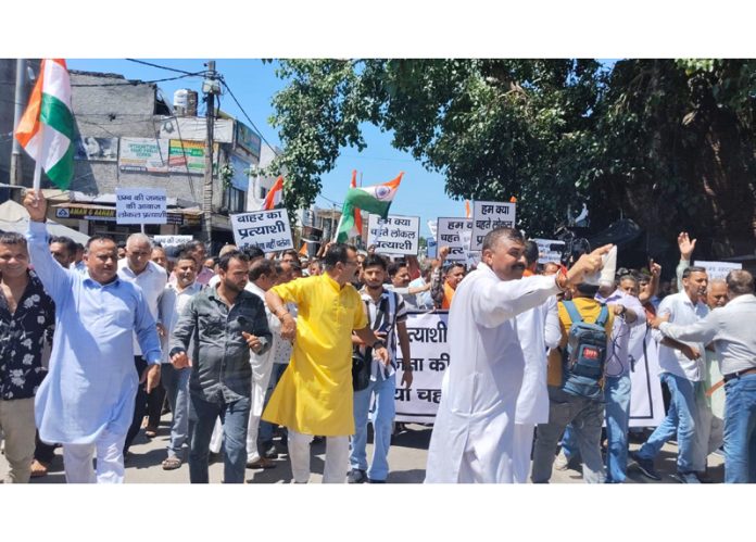 BJP activists protesting at Khour against fielding of non local candidate on Saturday. BJP activists protesting at Khour against fielding of non local candidate on Saturday.