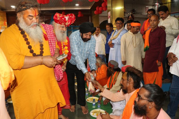 Devotees being served prasad at Baba Sidhgoria Dham at Paloura in Jammu on Sunday. Devotees being served prasad at Baba Sidhgoria Dham at Paloura in Jammu on Sunday.