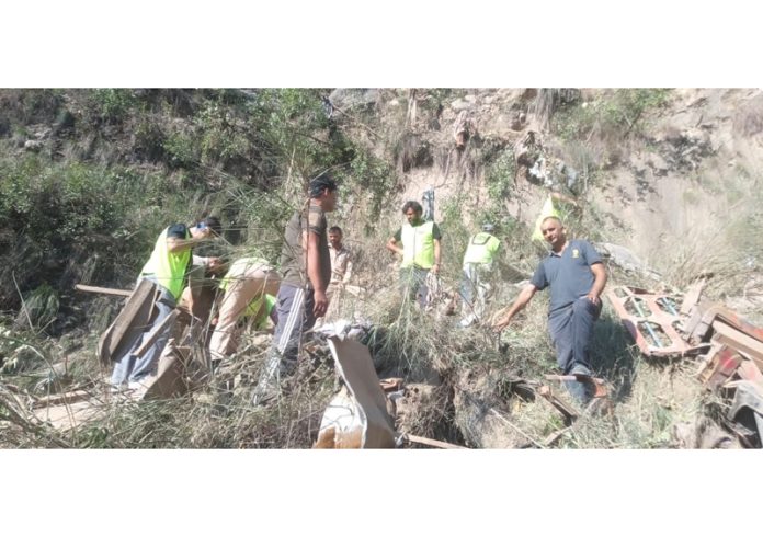 Locals and rescue workers at accident site in Doda on Friday. -Excelsior/Tilak Raj Locals and rescue workers at accident site in Doda on Friday. -Excelsior/Tilak Raj