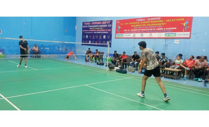 Badminton players in action during selection trials at Jammu.