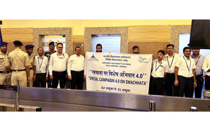 AAI and CISF personnel during the cleanliness drive at Jammu Airport on Monday.