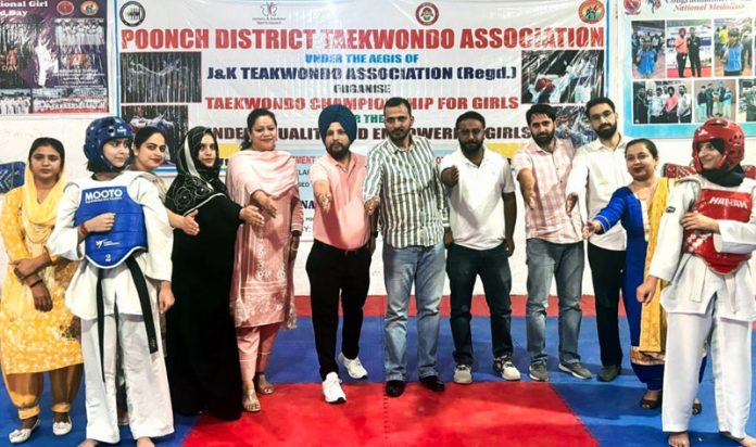 Tehsildar Haveli, Azhar Majeed posing along with Taekwondo girls during opening ceremony at Poonch. Tehsildar Haveli, Azhar Majeed posing along with Taekwondo girls during opening ceremony at Poonch.