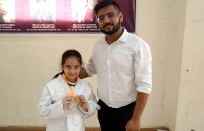 Hetika Gupta displaying Gold medal while posing with a dignitary at Indoor Complex, Bhagwati Nagar in Jammu. Hetika Gupta displaying Gold medal while posing with a dignitary at Indoor Complex, Bhagwati Nagar in Jammu.