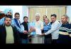Delegation of All J&K Transport Welfare Association presenting bouquet to LG Manoj Sinha.