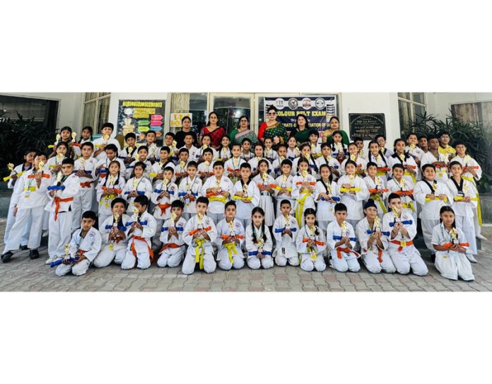 Martial art athletes posing for group photograph along with medals. Martial art athletes posing for group photograph along with medals.