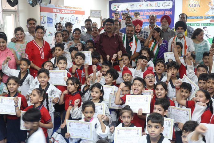 Young Taekwondo players posing during Belt Grading Championship at Sai Palace, Jammu. -Excelsior/Rakesh