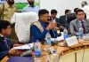 Minister Javed Rana chairing a meeting.