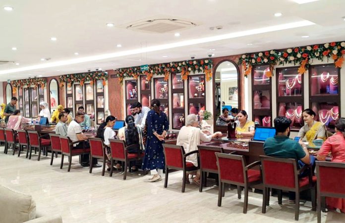 Customers busy in purchasing jewellery at Tanishq outlet in Jammu on Tuesday.