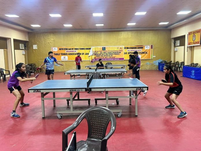 Table Tennis players in action during a match at MA Stadium Jammu on Sunday.