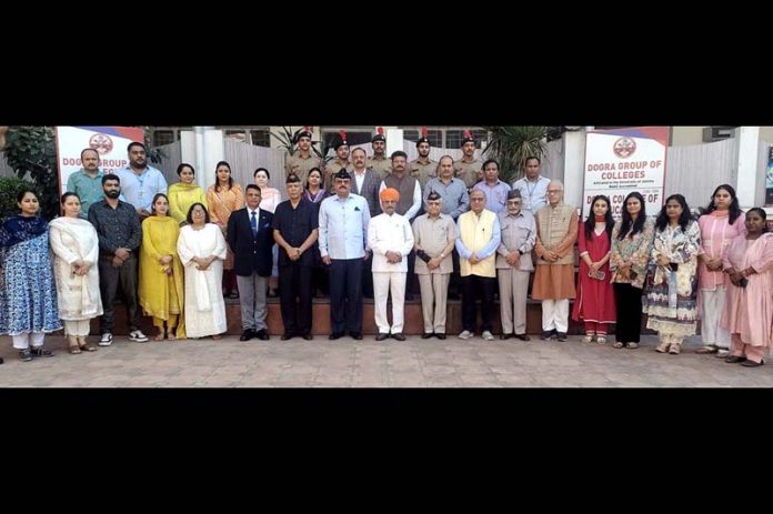 Dignitaries pose for a group photograph during a function at Dogra Group of Colleges on Friday.