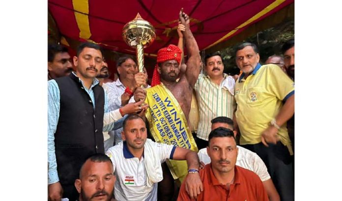 Winner wrestler posing along with dignitaries during Dangal event at Reasi.