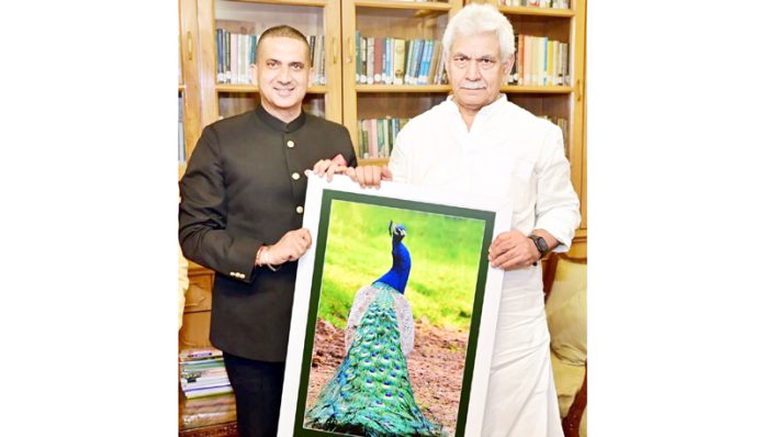Lt Governor Manoj Sinha being presented with the pictorial art-work “Pride of Peacock is Glory of India” by Harpreet Sandhu.