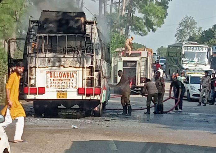 Firemen extinguishing fire which broke out in a passenger bus near Katra on Friday. -Excelsior/ Mengi