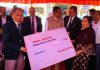 CJ and Administrative Judge giving cheque to a MACT petitioner.