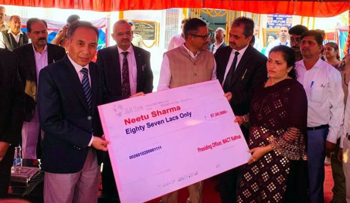 CJ and Administrative Judge giving cheque to a MACT petitioner. CJ and Administrative Judge giving cheque to a MACT petitioner.