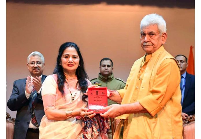 LG felicitating a writer on Thursday.