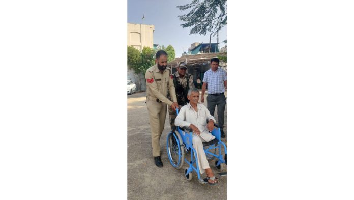 Cops helping physically challenged person to cast vote in Jammu.
