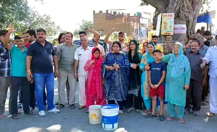Villagers protesting for regular water supply in Jakhani and adjoining areas. -Excelsior/K.Kumar