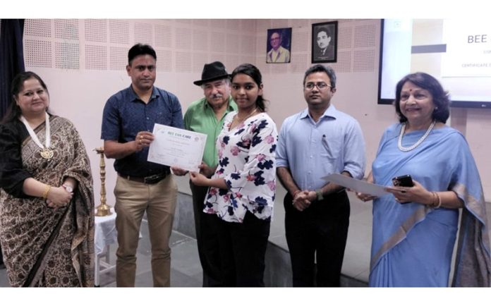 Renowned psychiatrist Dr Abhishek Chauhan presenting certificate to a student during a contact program.
