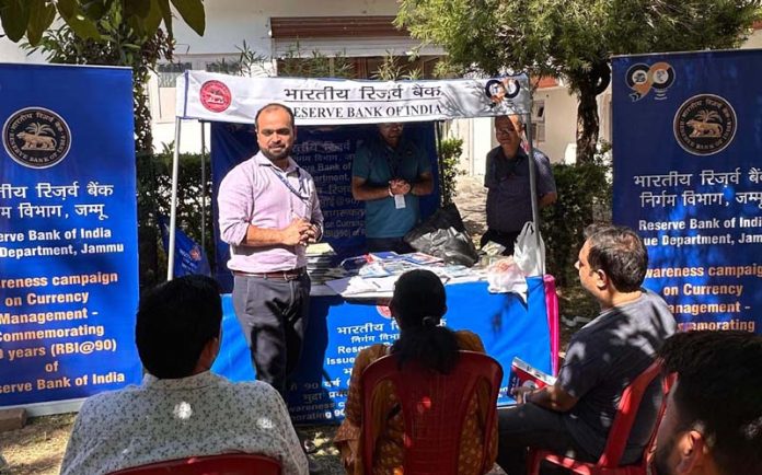 An RBI official educating people on security features of currency notes during a camp in Katra. An RBI official educating people on security features of currency notes during a camp in Katra.