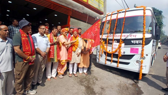 Advocate General of J&K, DC Raina flagging off a bus of JYBT Haridwar.