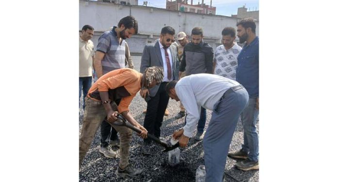 DC Rajouri, Abhishek Sharma inspecting blacktopping work at Bela Bus Stand.