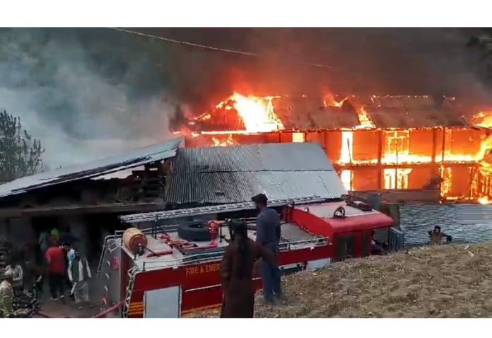 A Madrassa on fire at Chatroo area of Kishtwar on Wednesday. - Excelsior/Tilak Raj