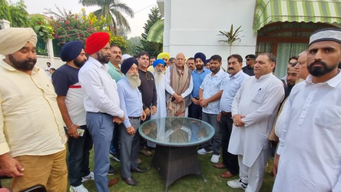 Transporters led by Karan Singh Wazir in a meeting with NC president Dr Farooq Abdullah.