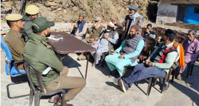 Police officers interacting with people during observance of Thana Diwas at one of the Police posts in kathua district on Friday
