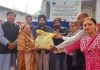 Dr Narinder Singh along with others distributing wheat seed variety.