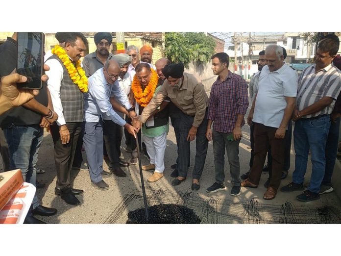 MLA Bahu, Ch Vikram Randhawa kickstarting blacktopping of road on Saturday. MLA Bahu, Ch Vikram Randhawa kickstarting blacktopping of road on Saturday.