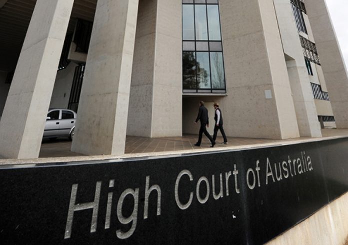 Australian High Court overturns law that forced scores of migrants to wear tracking bracelets