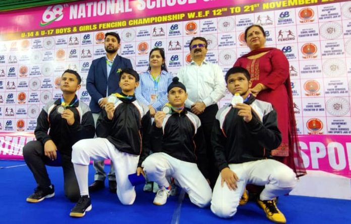 J&K Fencers posing along with medals at University of Jammu's Gymnasium Hall. — Excelsior/Rakesh