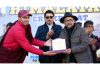 Dignitaries presenting memento to winning team member during a cricket tournament at Leh.