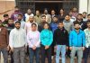 Selected wrestlers posing along with dignitaries.