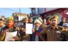 Police with drum beaters issuing warning to 14 proclaimed offenders to surrender within 30 days at Koranka town in Rajouri on Friday.