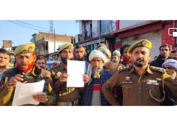 Police with drum beaters issuing warning to 14 proclaimed offenders to surrender within 30 days at Koranka town in Rajouri on Friday. Police with drum beaters issuing warning to 14 proclaimed offenders to surrender within 30 days at Koranka town in Rajouri on Friday.