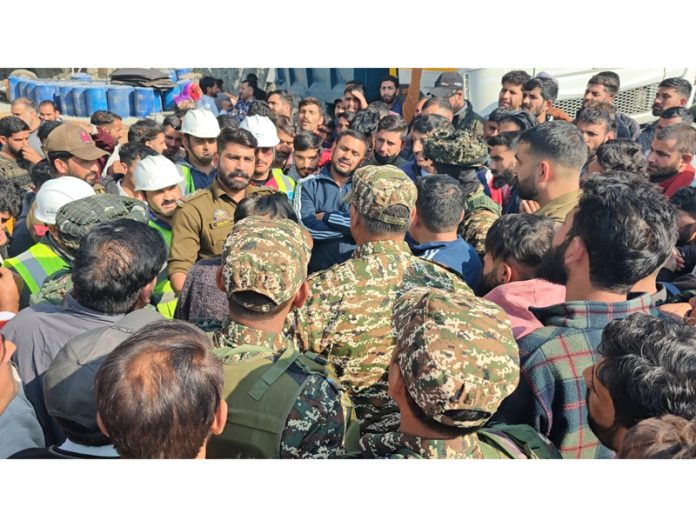 Assistant Labour Commissioner, Amit Kumar during talks with the agitating workers in Ramban on Tuesday. Assistant Labour Commissioner, Amit Kumar during talks with the agitating workers in Ramban on Tuesday.