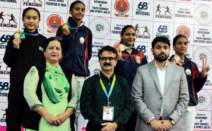 Dignitaries posing along with medallists during medal ceremony of 68th National School Games event at Jammu.