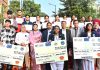 Dignitaries from NHPC and students who participated in painting competition organised in Jammu on Tuesday.