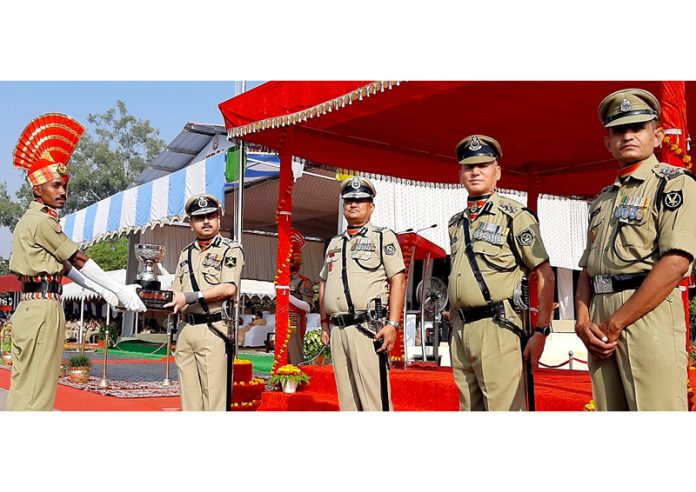 Puneet Rastogi, ADG BSF presenting trophy to a recruit constable in Udhampur on Saturday. Puneet Rastogi, ADG BSF presenting trophy to a recruit constable in Udhampur on Saturday.