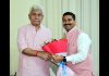 Former general secretary of CCI Jammu, Gaurav Gupta presenting a bouquet to LG Manoj Sinha.
