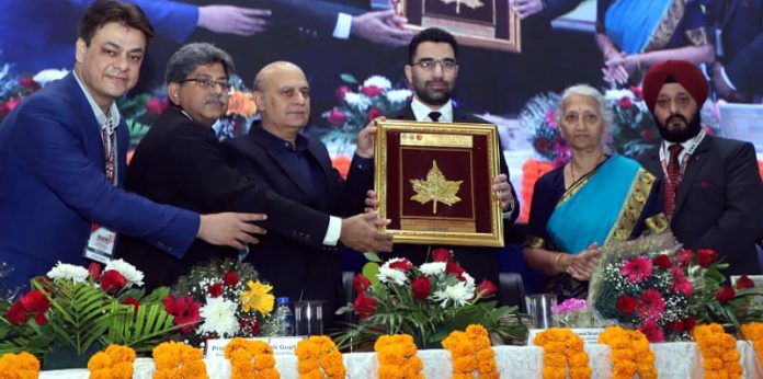 Principal, GMC Jammu, Dr Ashutosh Gupta and other doctors presenting a souvenir to Secretary H&ME, Dr Syed Abid Rasheed Shah at valedictory function of SAJCON 2024.